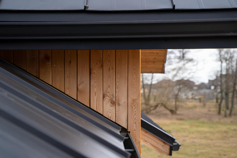 wooden house with sleek black rain gutters